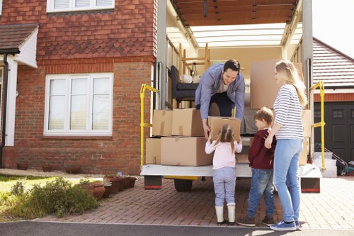 Removal crew handling furniture with care in South Harrow