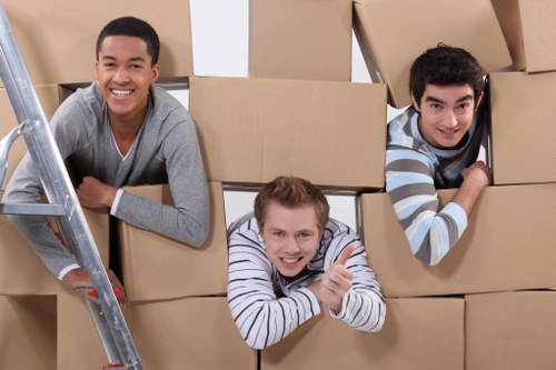 Office furniture and equipment being moved by a local removals team